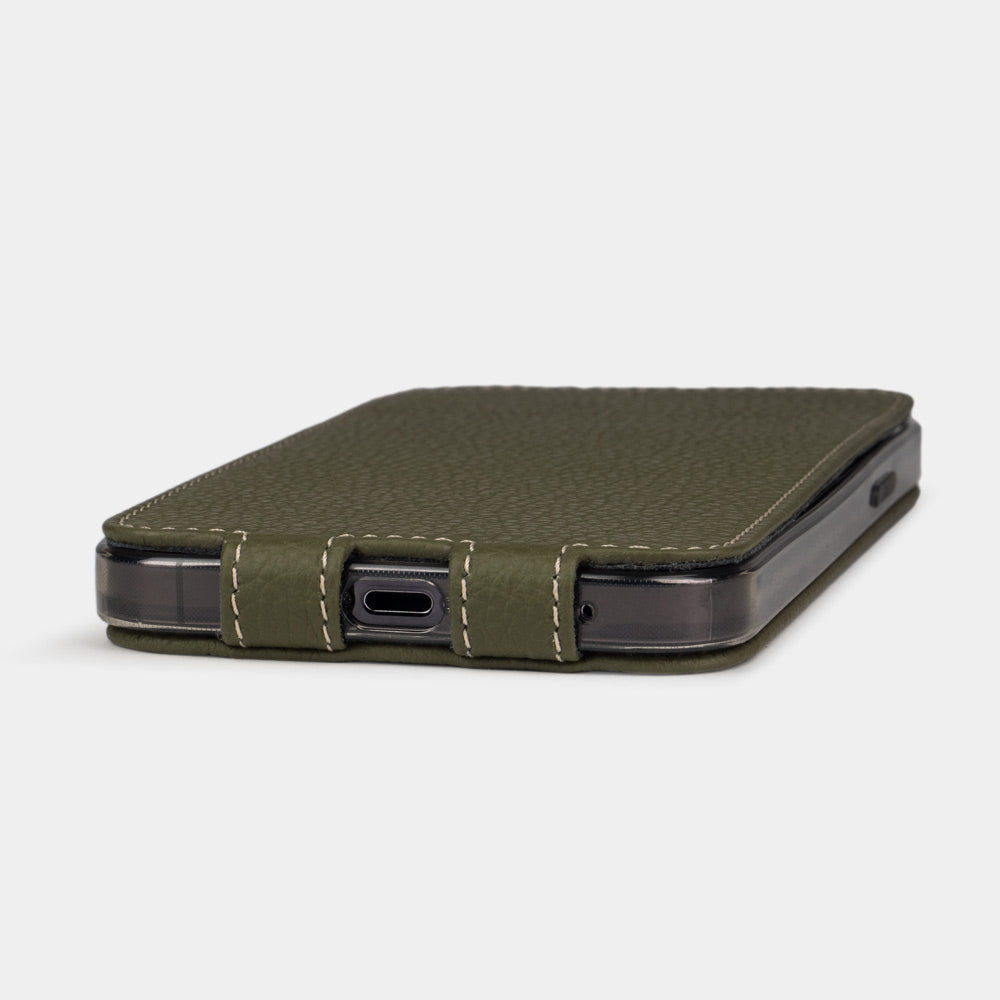iPhone 14 flip case made with green premium leather – the case laid flat on the table, showing its slimness and the beauty of the leather grain