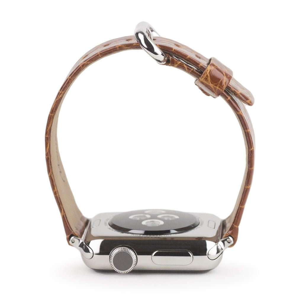 Strap for the Apple Watch 45/46 mm in Gold shiny alligator leather, with steel adapters and buckle | watch case on bottom to see leather texture, inner lining and the buckle