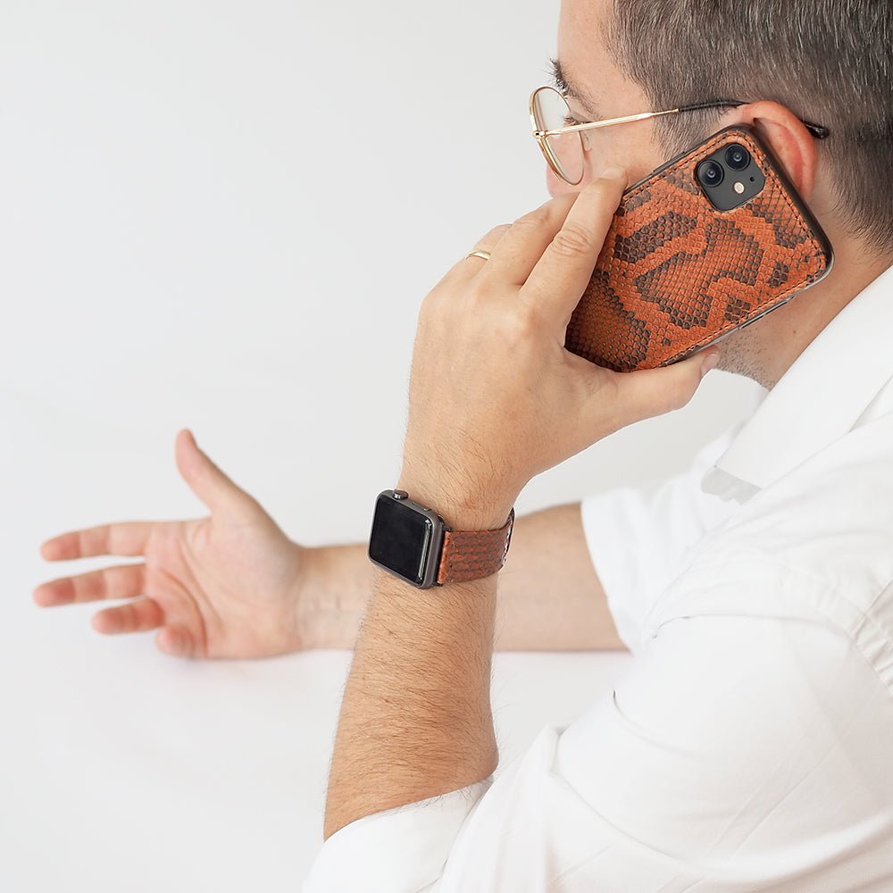 gold python strap apple watch with black adapters and buckle contextual image