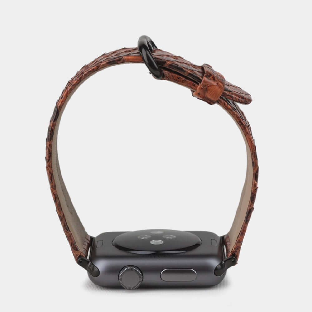 Strap for the Apple Watch 41/42 mm in Gold python leather, with black adapters and buckle | watch case on bottom to see leather texture, inner lining and the buckle