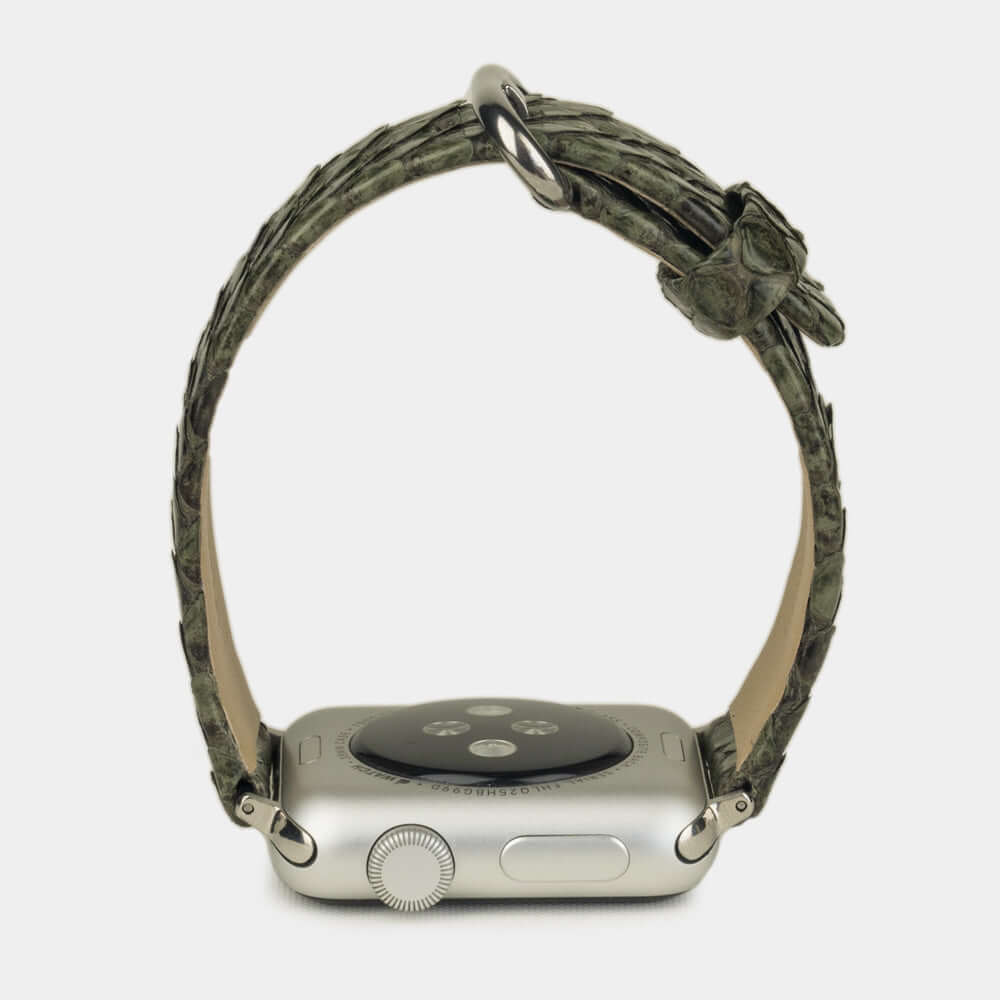 Strap for the Apple Watch 41/42 mm in green python leather, with steel adapters and buckle | watch case on bottom to see leather texture, inner lining and the buckle