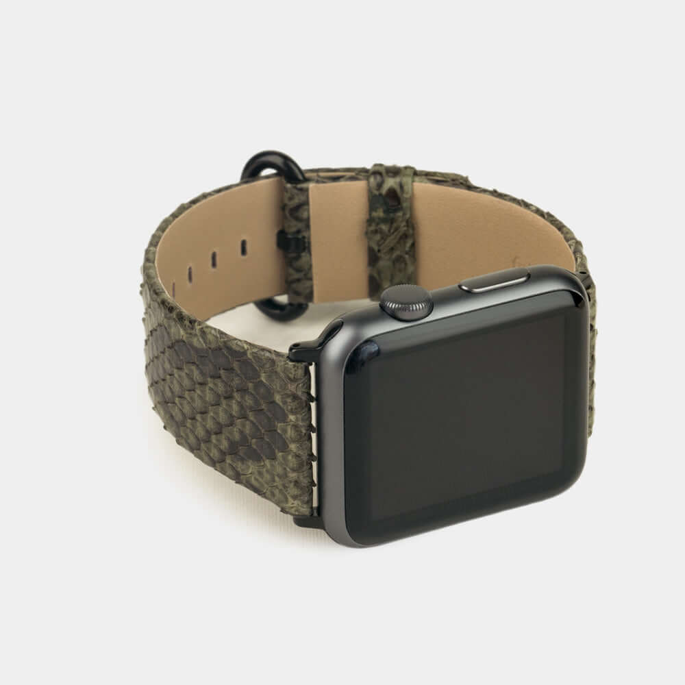 Strap for the Apple Watch 41/42 mm in green python leather, with black adapters and buckle | 3/4 profile view to see the inner lining leather