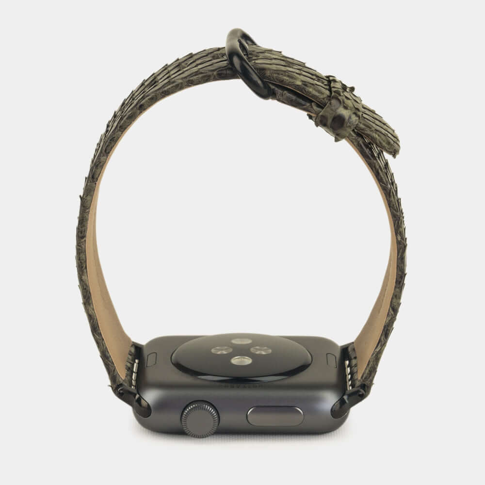 Strap for the Apple Watch 41/42 mm in green python leather, with black adapters and buckle | watch case on bottom to see leather texture, inner lining and the buckle