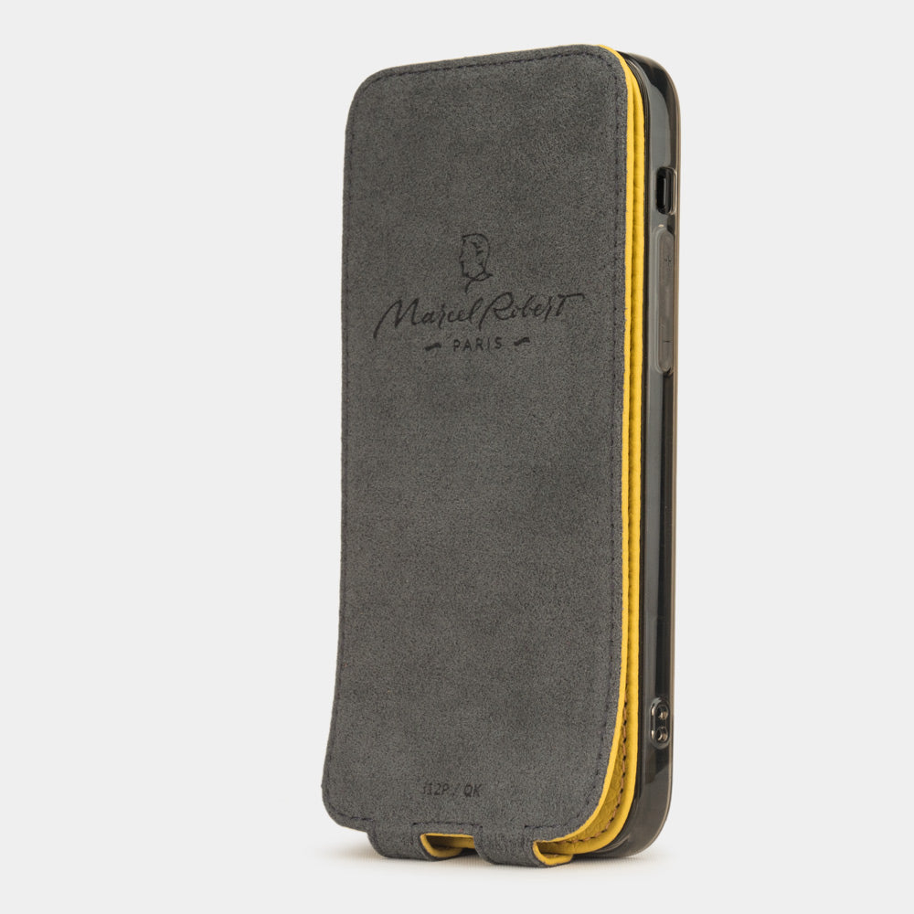 Yellow leather flip case for iPhone 12 mini, vertical position, cover folded and secured to the back of the iPhone thanks to its integrated magnet system, revealing the grey microfibre lining