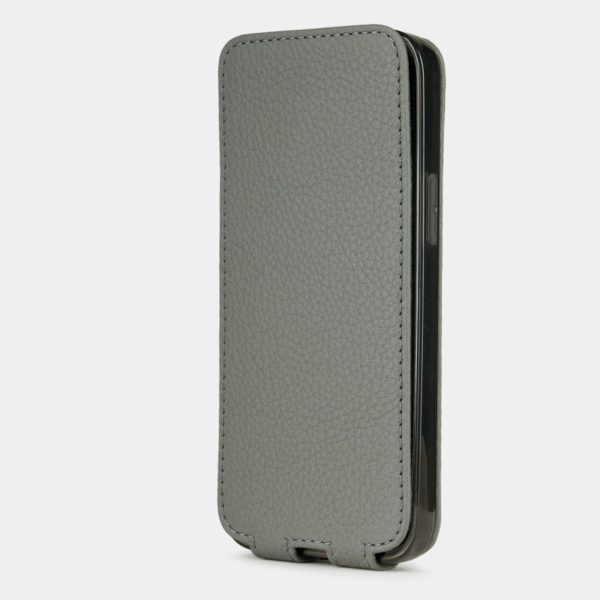 gray leather iphone 12 mini flip case in an upright position, cover closes securely thanks to its integrated magnet system