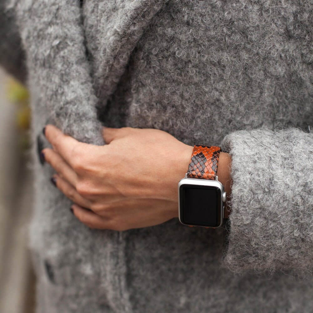 Strap for the Apple Watch 41/42 mm in Gold python leather, with steel adapters and buckle | lifestyle photo, the strap worn on a woman's wrist