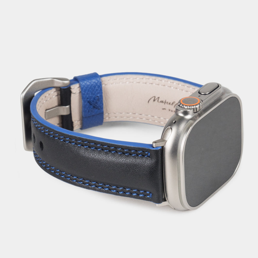 Men's Apple Watch Ultra band 49mm in black smooth calfskin leather with blue edge finish and its titanium color adapters - 3/4 profile view