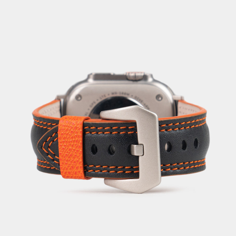 Men's Apple Watch Ultra band 49mm in black smooth calfskin leather with orange edge finish and its titanium color adapters - main view