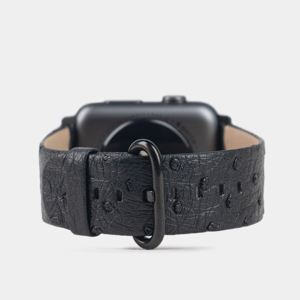 Strap for the Apple Watch 41/42 mm in black ostrich leather, with black adapters and buckle | 3/4 profile view to see the inner lining leather