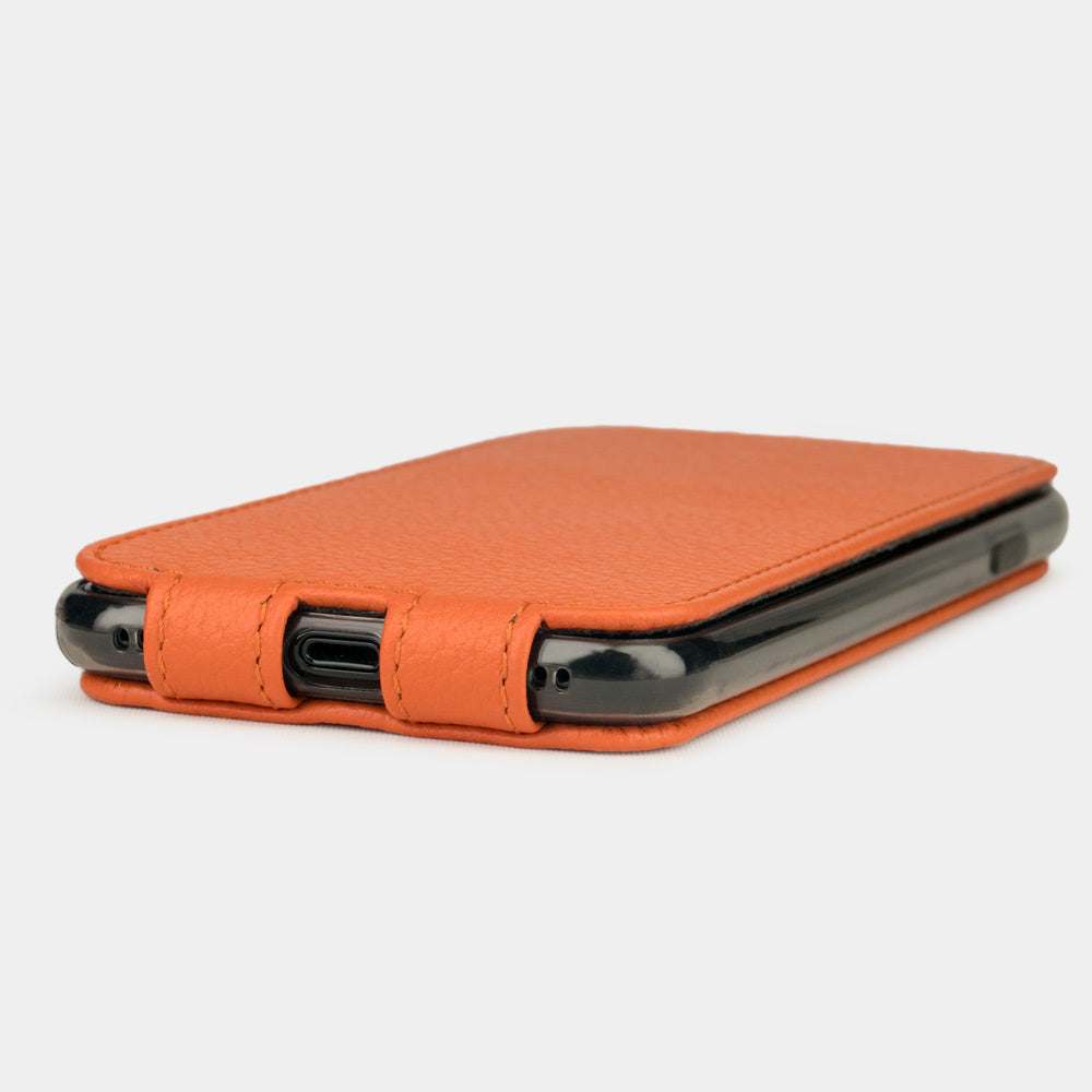 Orange leather flip case for iPhone SE - flat side view displaying ultra-thin handcrafted design, Lightning port opening and precise edge finishing