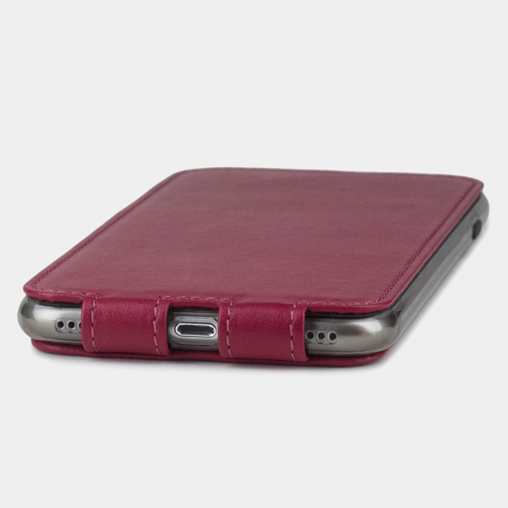 Fuchsia leather flip case for iPhone SE - flat side view displaying ultra-thin handcrafted design, Lightning port opening and precise edge finishing