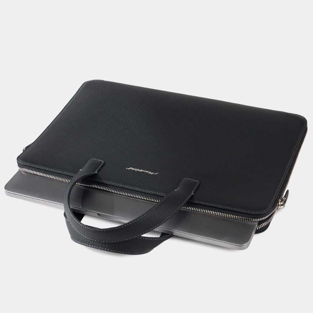 Slim 14 inch black leather laptop bag closed, minimalist professional design