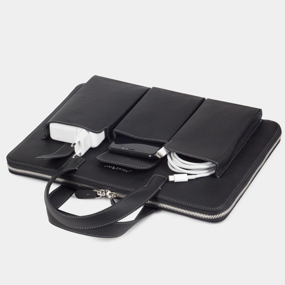 Men’s black 14 inch leather laptop bag with pockets holding laptop and charger, executive business layout