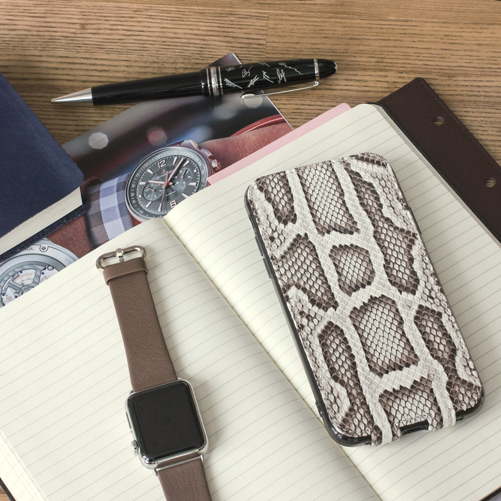 Natural python leather flip case for iPhone X - flat lay with notebook and Apple Watch