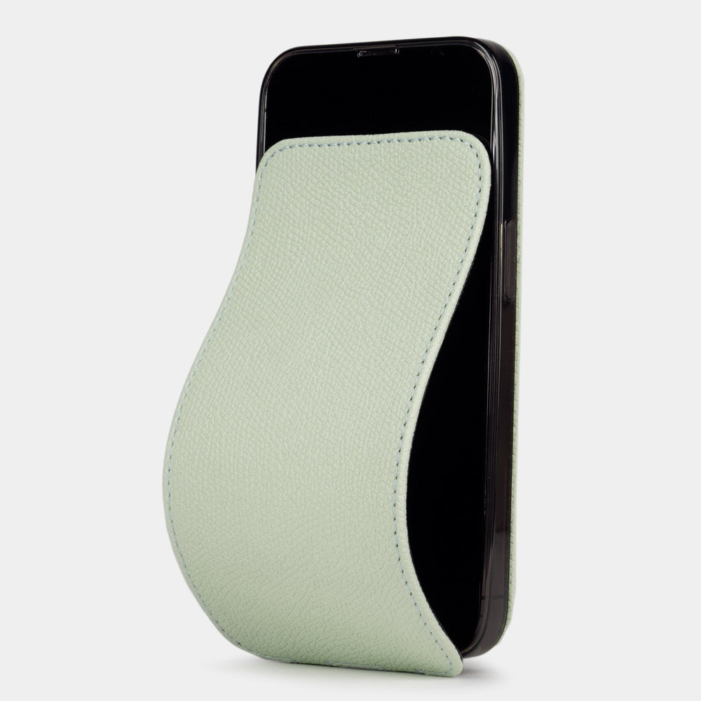 Pastel green calfskin leather flip case for iPhone 15 Plus – folding magnetic flap curving away to clean the screen