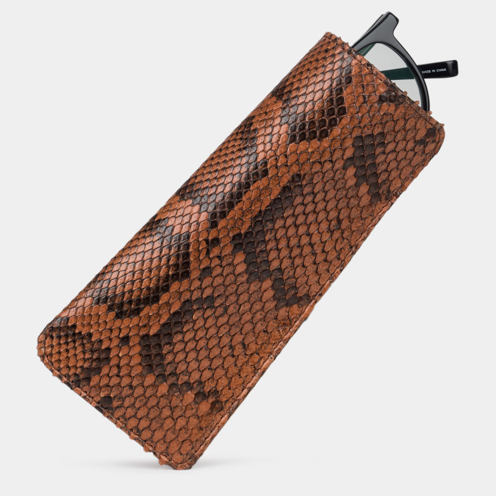 Pocket glasses pouch in gold python with glasses slipping out of the top