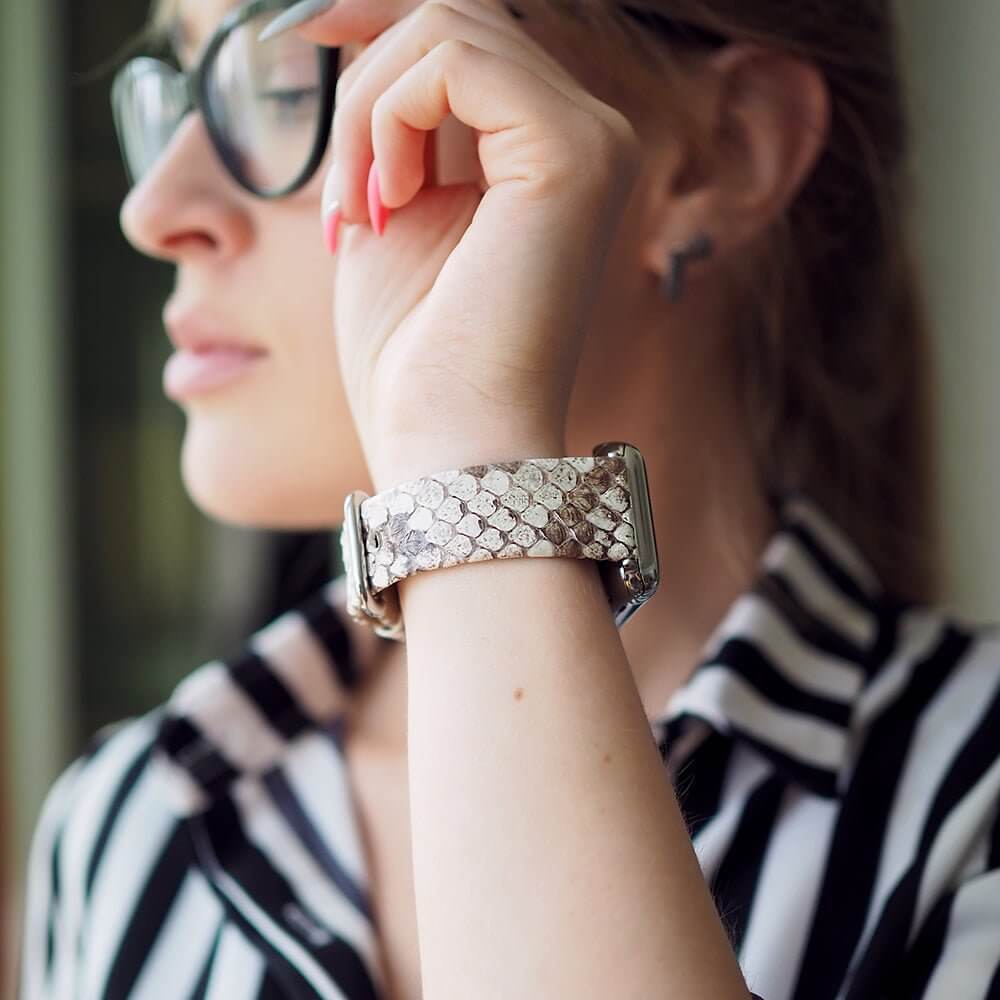 Strap for the Apple Watch 41/42 mm in natural python leather, with steel adapters and buckle | lifestyle photo, the strap worn on a woman's wrist