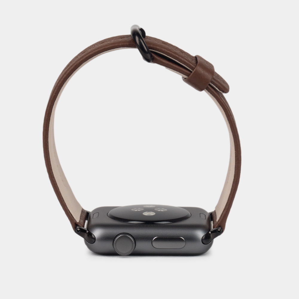 Strap for the Apple Watch 41/42 mm in brown soft grained calfskin leather, with black adapters and buckle | front view of the strap looped around the watch case