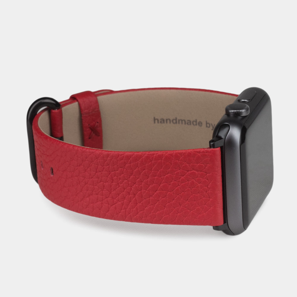 Strap for the Apple Watch 41/42 mm in red soft grained calfskin leather, with black adapters and buckle | 3/4 profile view to see the inner lining leather