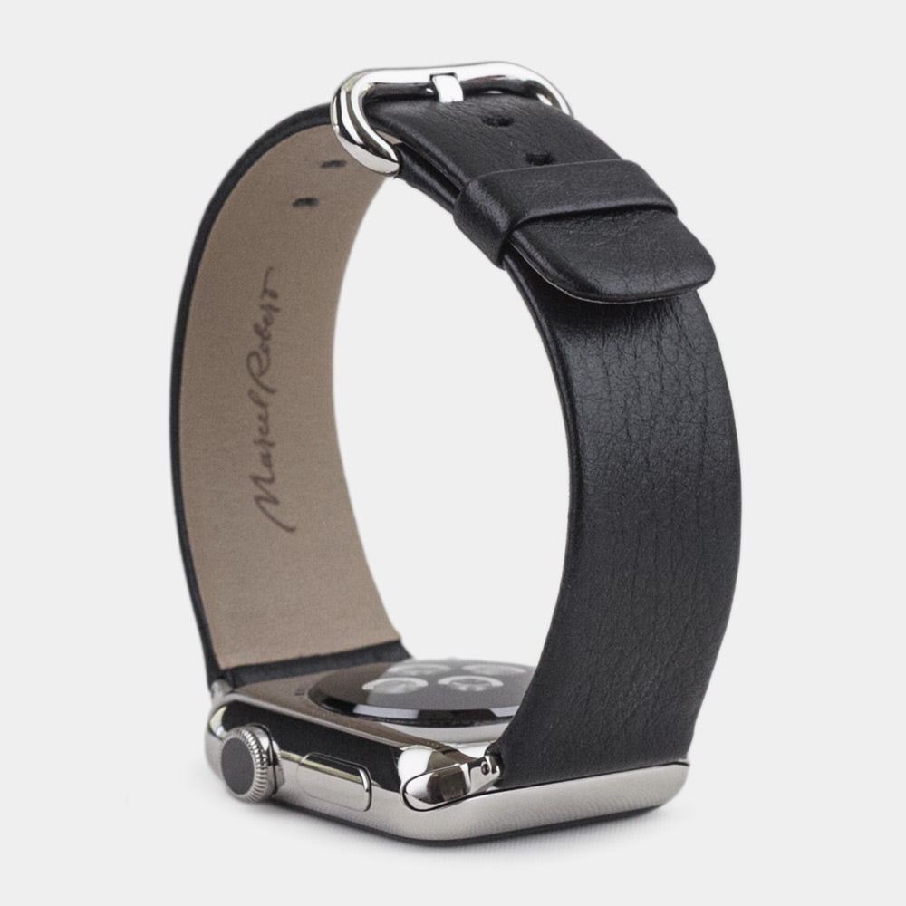 Strap for the Apple Watch 45/46 mm in black smooth calfskin leather, with steel adapters and buckle | watch case on bottom to see leather texture, inner lining and the buckle