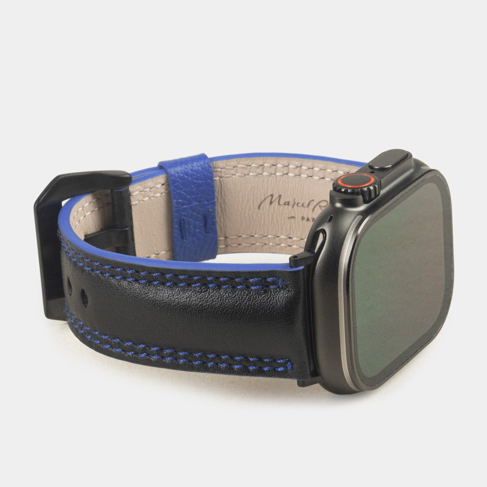 Men's Apple Watch Ultra band 49mm in black smooth calfskin leather with blue edge finish and its black color adapters - 3/4 profile view