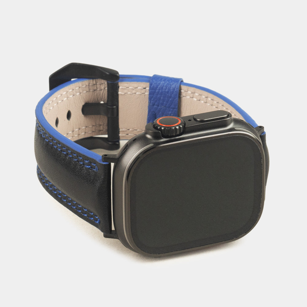 Men's Apple Watch Ultra band 49mm in black smooth calfskin leather with blue edge finish and its black color adapters - front dial view