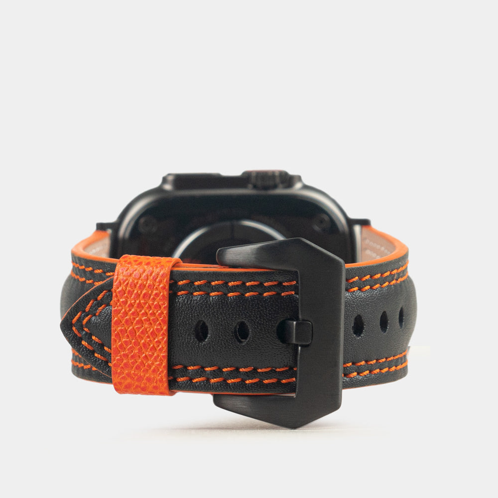 Men's Apple Watch Ultra band 49mm in black smooth calfskin leather with orange edge finish and its black color adapters - main view