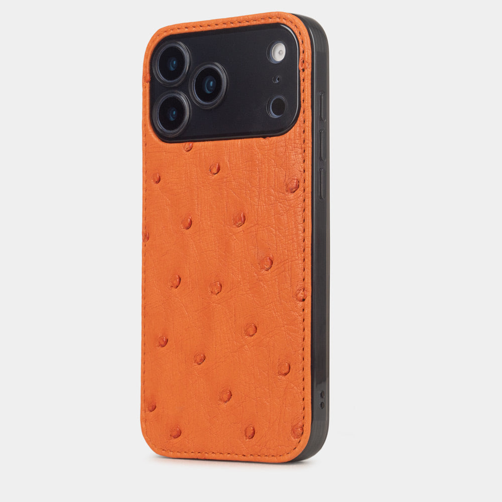 iPhone 17 Pro & Pro Max cover case in orange ostrich leather – three-quarter back view on a silver iPhone