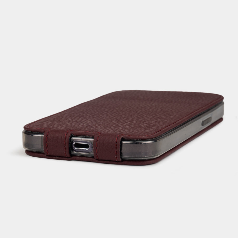 iPhone 14 Pro flip case made with bordeaux premium leather – the case laid flat on the table, showing its slimness and the beauty of the leather grain