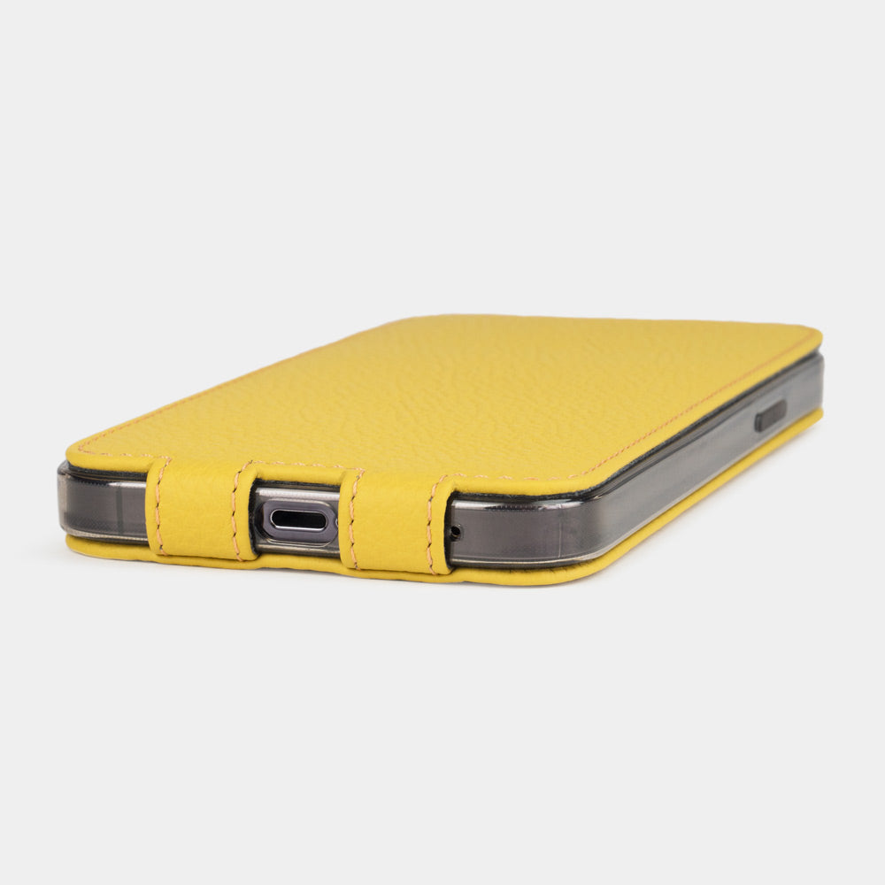 iPhone 14 Pro flip case made with yellow premium leather – the case laid flat on the table, showing its slimness and the beauty of the leather grain