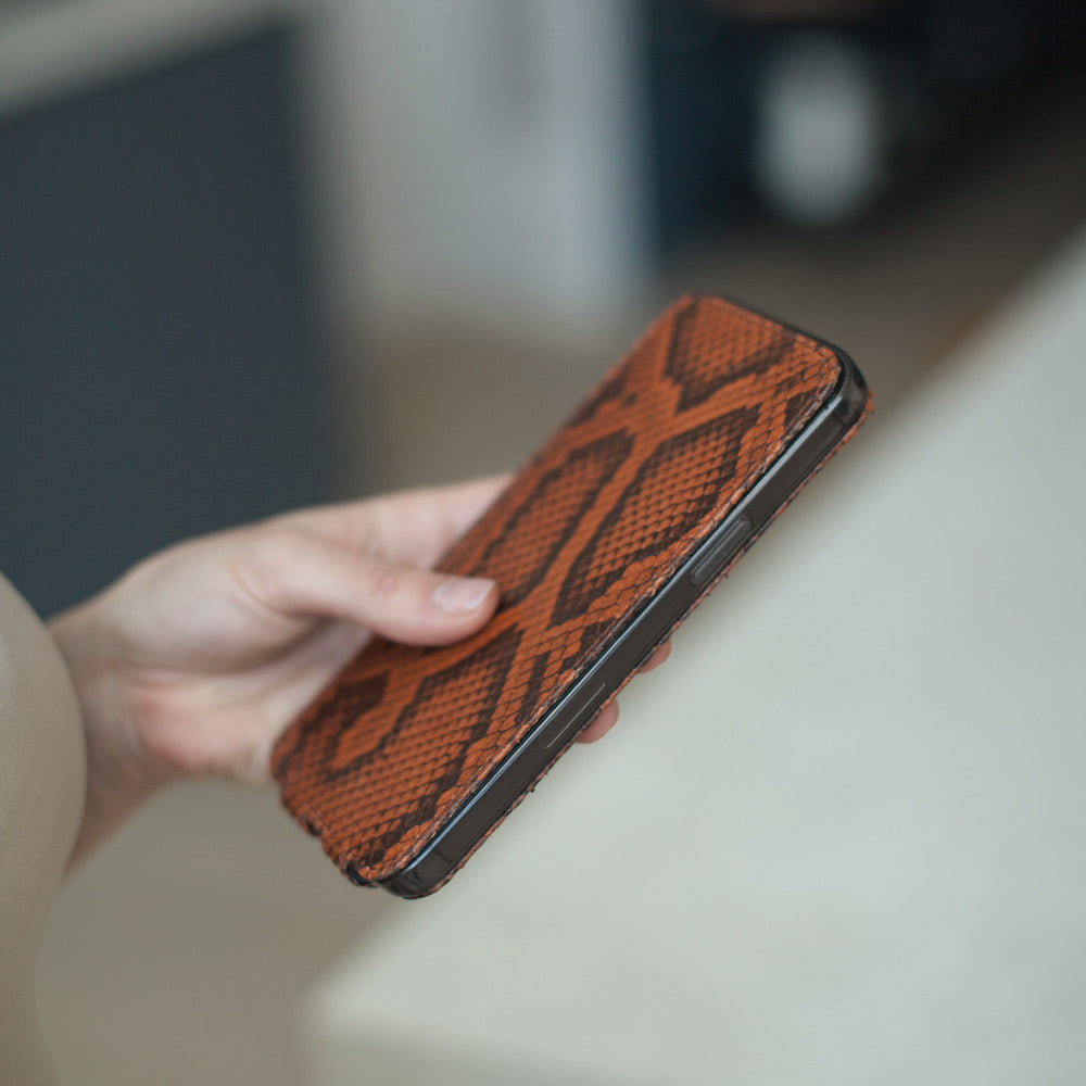 Gold python iPhone 14 Pro Max case, in hand