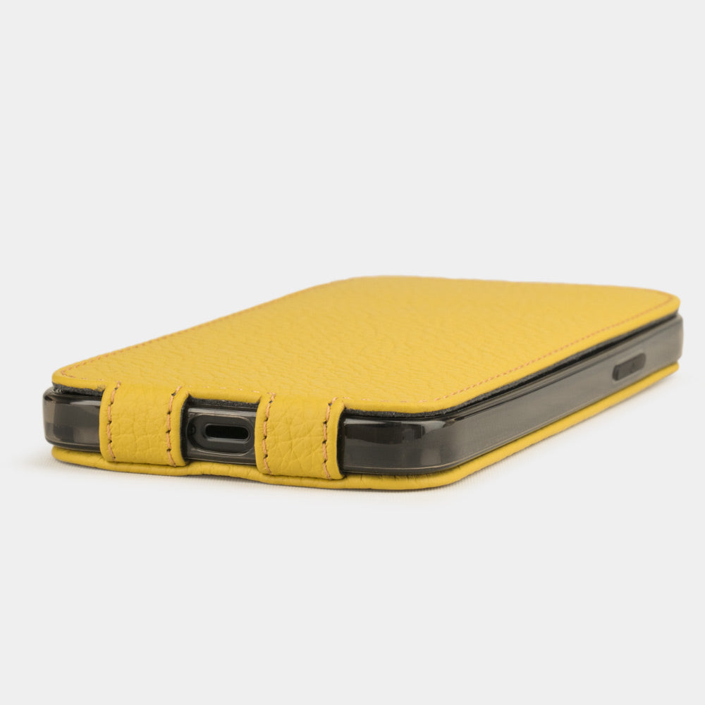 Yellow leather flip case for iPhone 12 mini, view of the case laid flat showing its slim profile