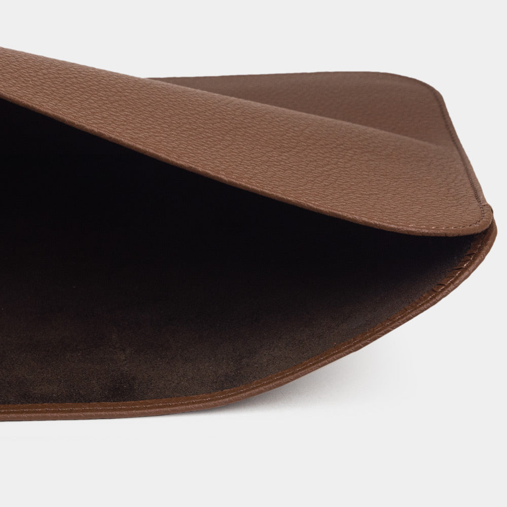 Brown 14 inch leather laptop sleeve with MacBook partially inserted, slim minimalist MacBook case