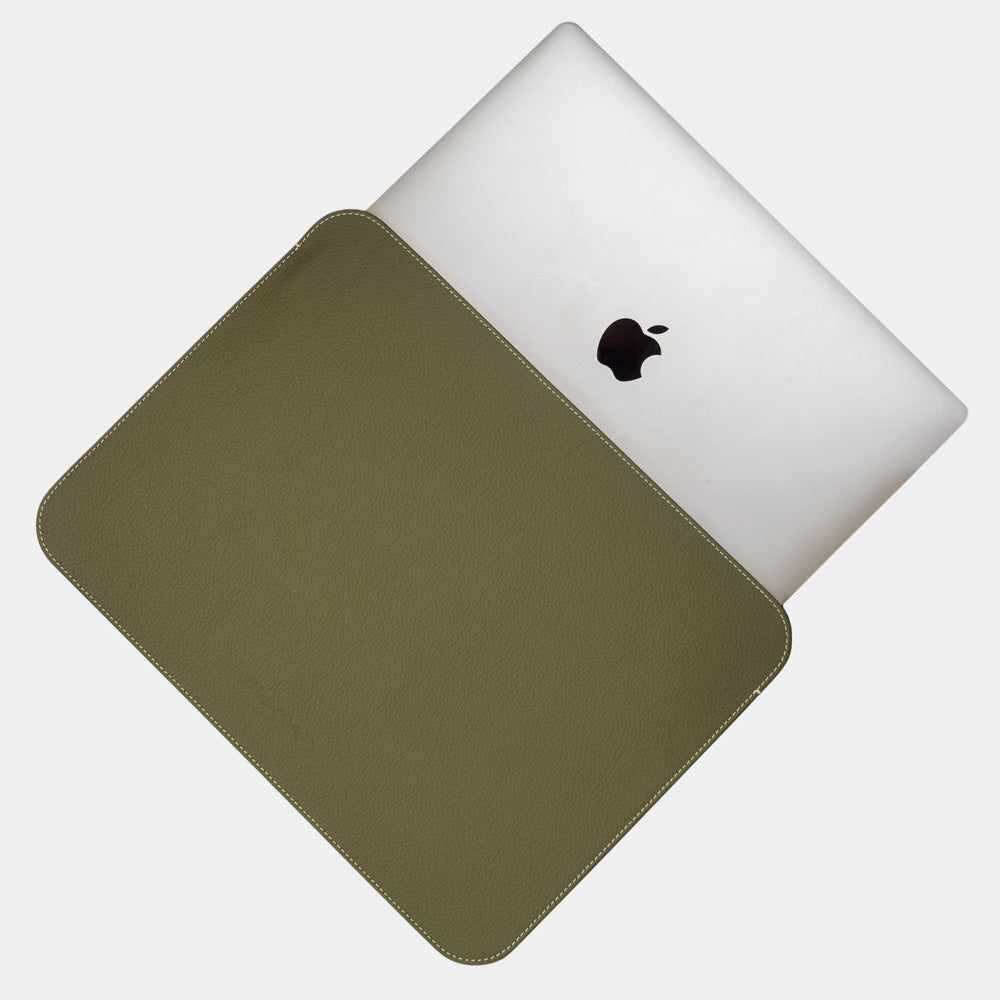 Slim green leather laptop sleeve 14 inch holding MacBook, minimalist protective laptop case