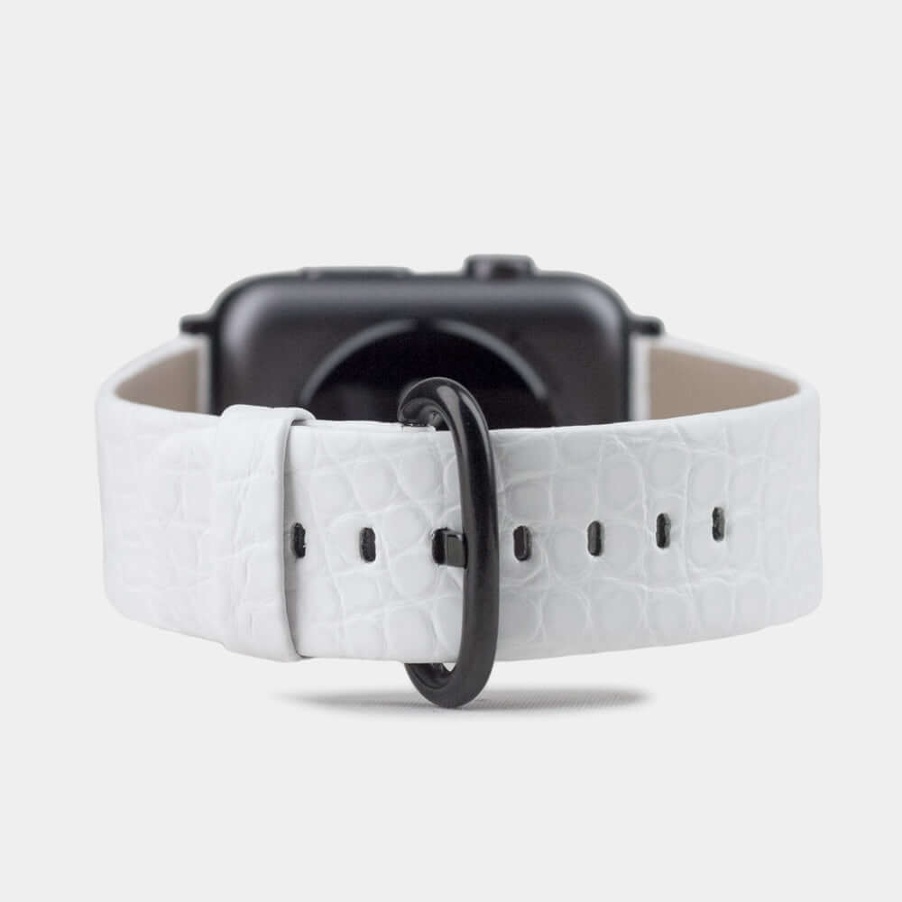 Strap for the Apple Watch 45/46 mm in white matte alligator leather, with black adapters and buckle | watch case on bottom to see leather texture, inner lining and the buckle