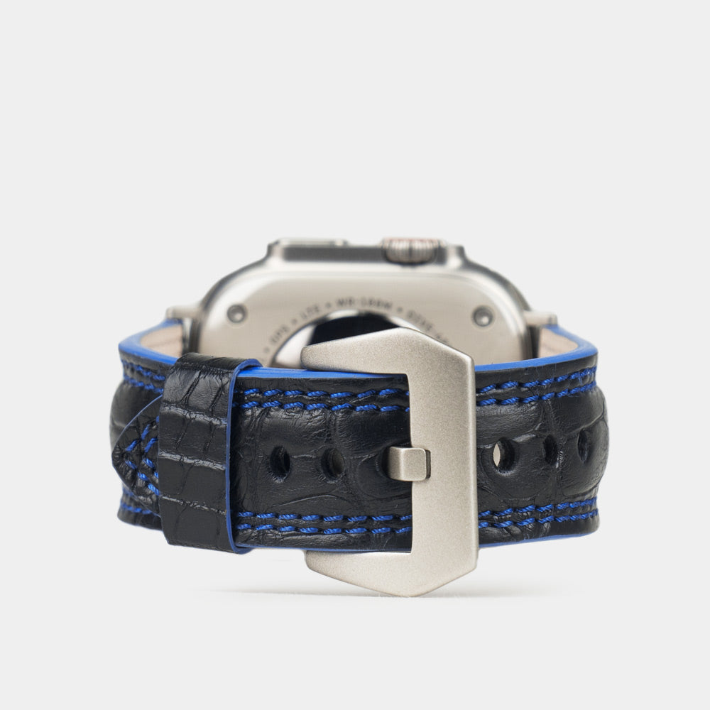 Apple Watch Ultra 49 mm in black alligator leather with blue stitching and edge, with titanium adapters and buckle | main image