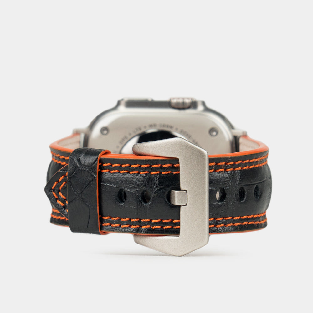 Apple Watch Ultra 49 mm in black alligator leather with orange stitching and edge, with titanium adapters and buckle | main image