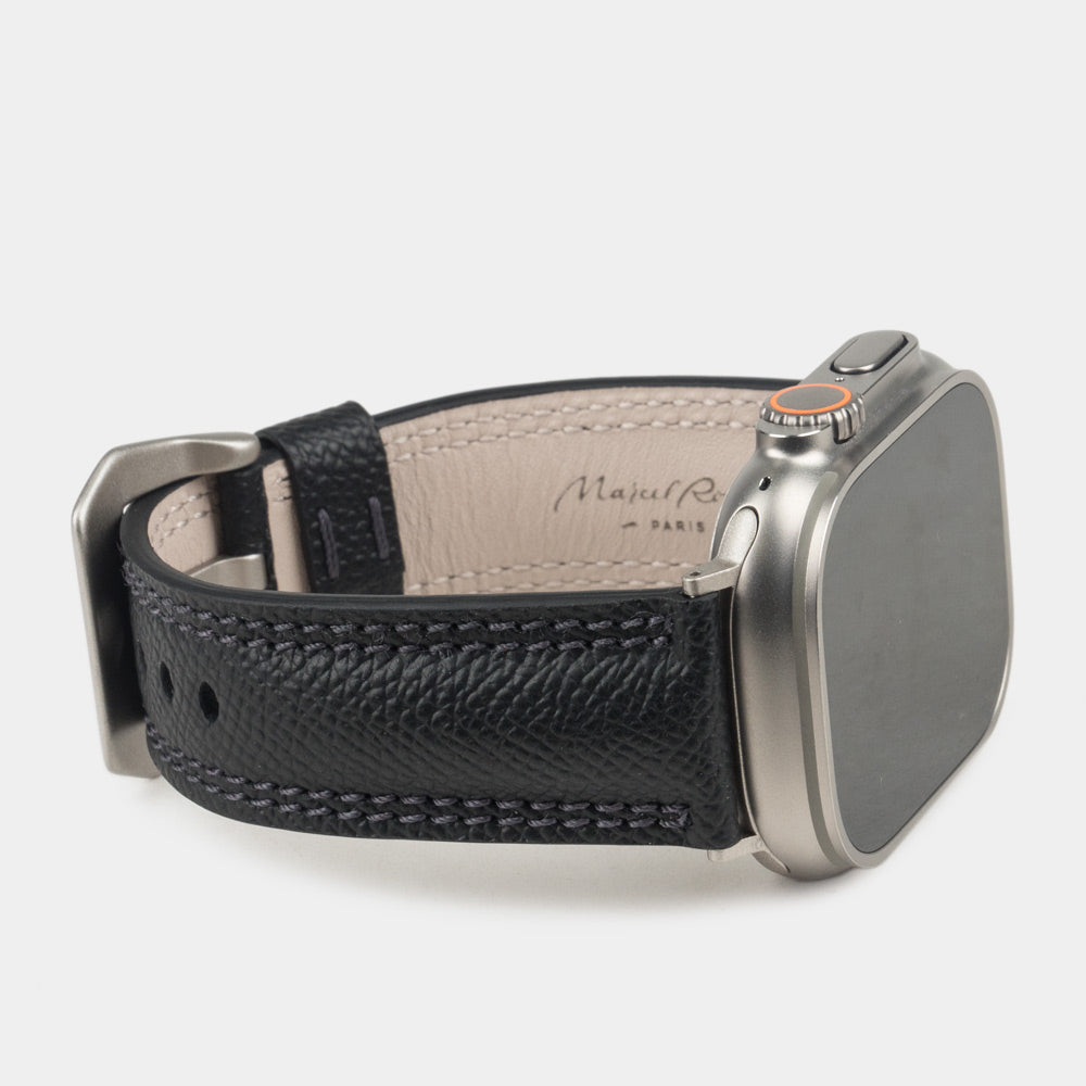 Men's Apple Watch Ultra band 49mm in black Epsom calfskin on the titanium Ultra case - three-quarter profile showing the cream leather lining stamped Marcel Robert Paris