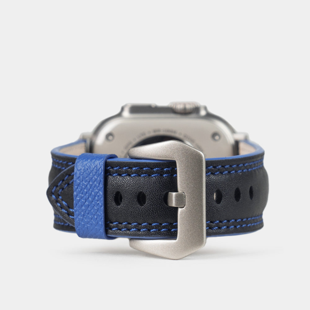 Men's Apple Watch Ultra band 49mm in black smooth calfskin leather with blue edge finish and its titanium color adapters - main view