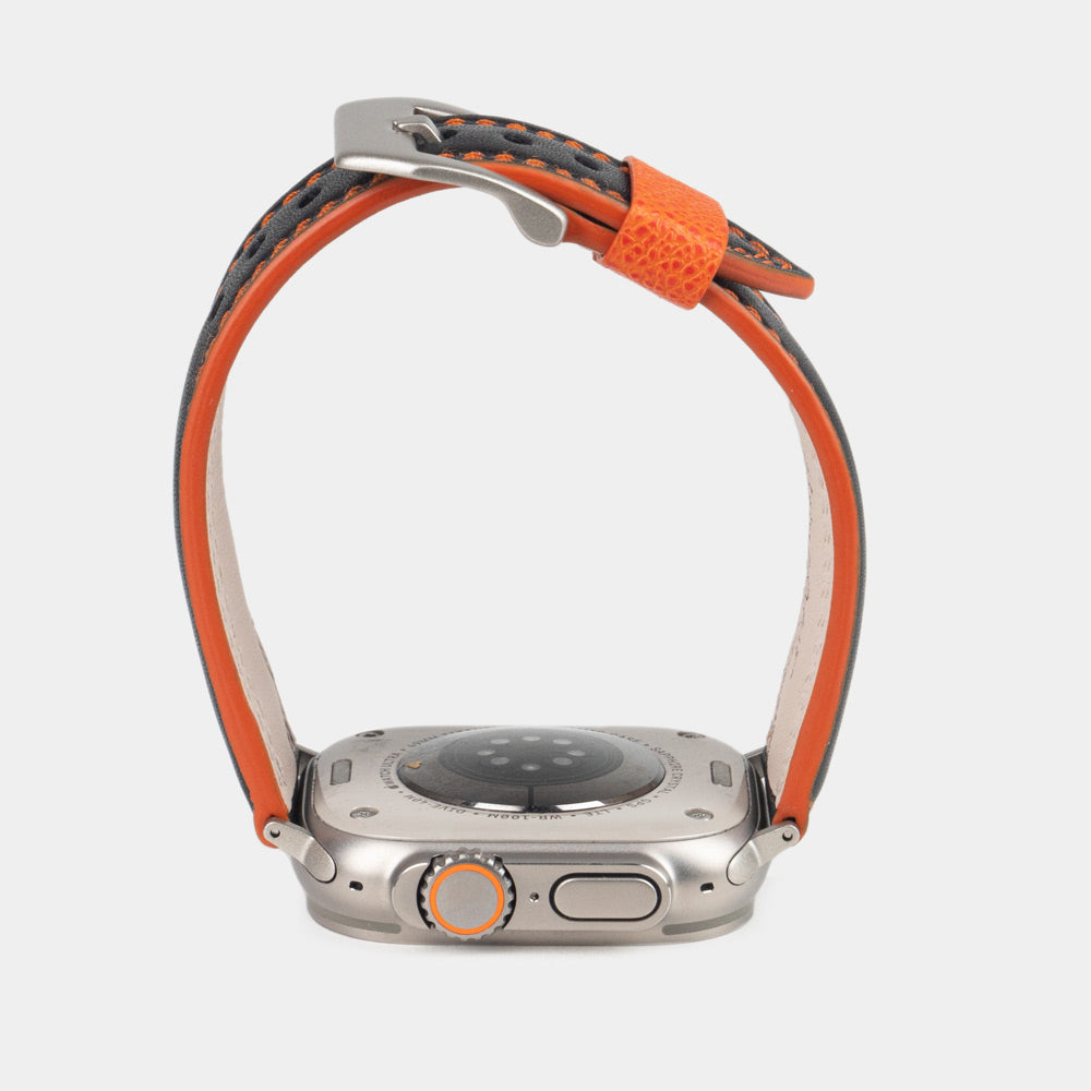 Men's Apple Watch Ultra band 49mm in black smooth calfskin leather with orange edge finish and its titanium color adapters - band orange color edge view