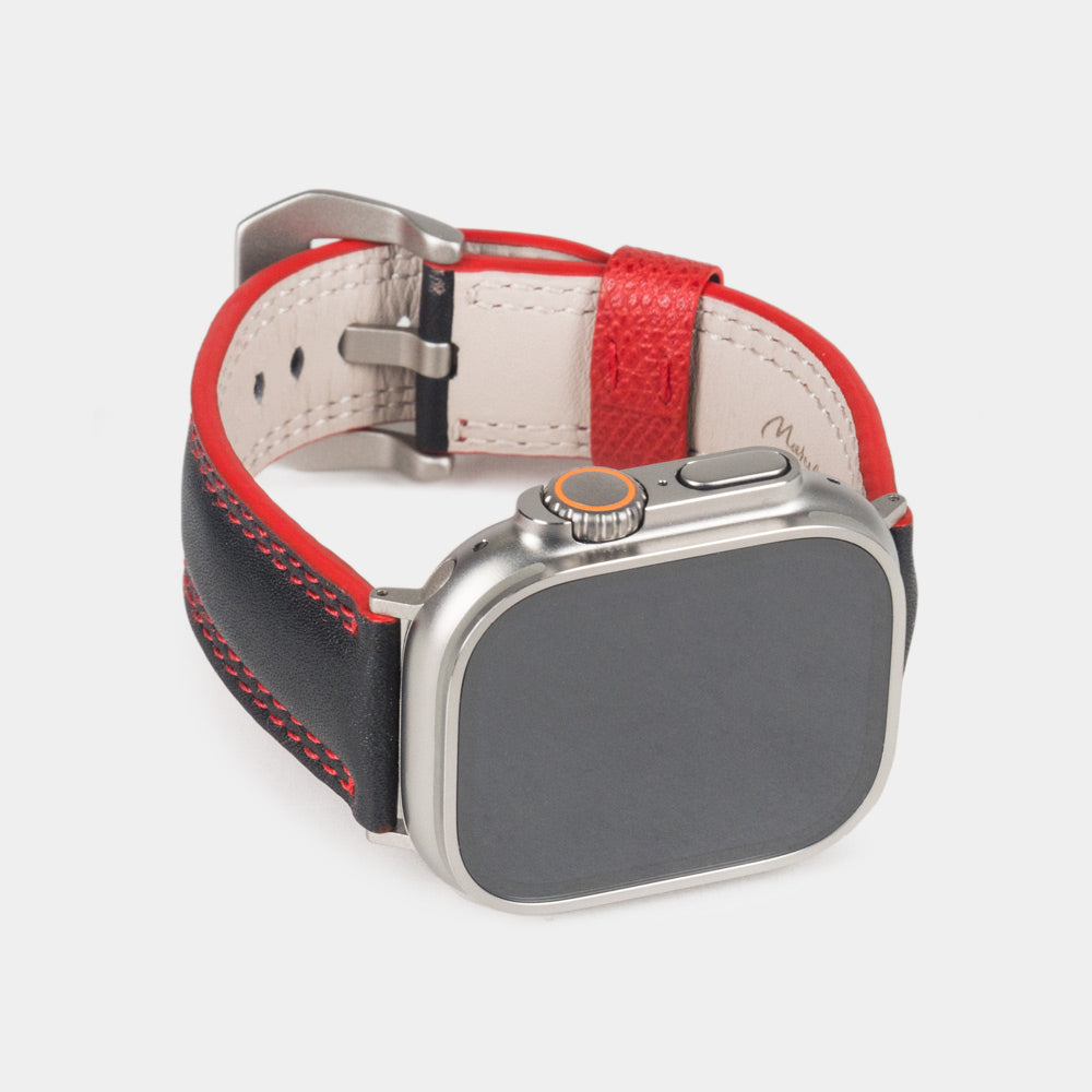 Men's Apple Watch Ultra band 49mm in black smooth calfskin leather with red edge finish and its titanium color adapters - front dial view
