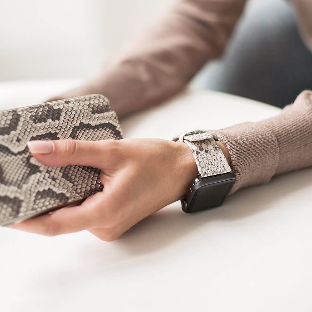 Strap for the Apple Watch 41/42 mm in natural python leather, with pink gold adapters and buckle | lifestyle photo, the strap worn on a woman's wrist