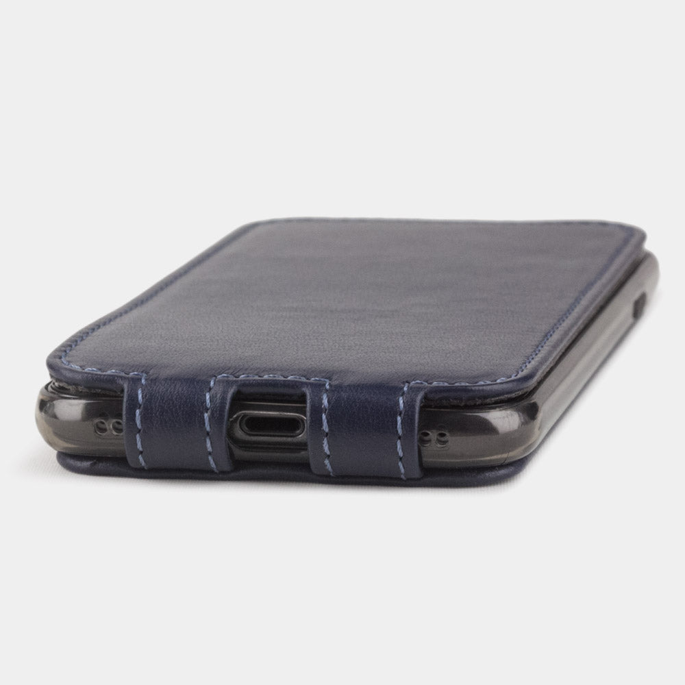 Indigo Blue leather flip case for iPhone SE - flat side view displaying ultra-thin handcrafted design, Lightning port opening and precise edge finishing