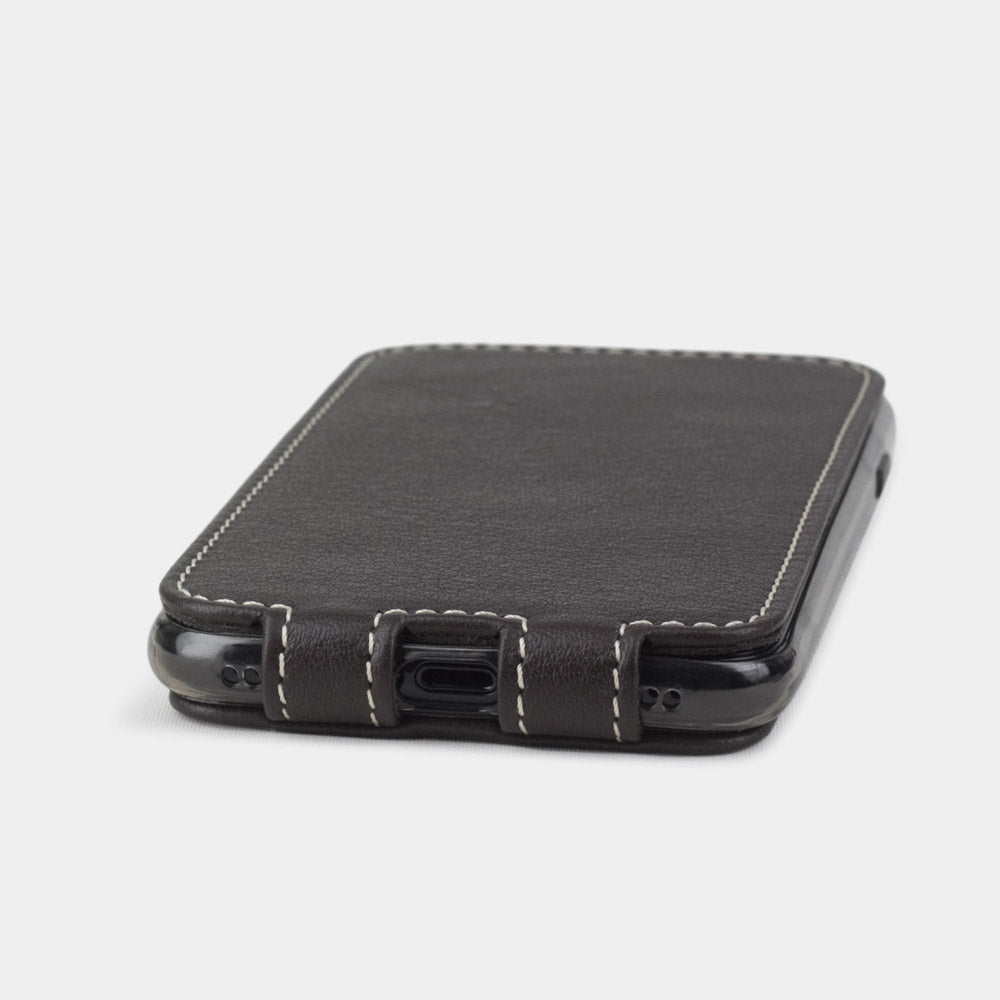 Brown leather flip case for iPhone SE - flat side view displaying ultra-thin handcrafted design, Lightning port opening and precise edge finishing