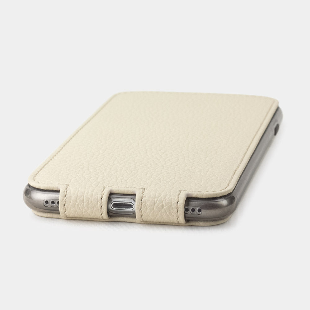 Cream leather flip case for iPhone SE - flat side view displaying ultra-thin handcrafted design, Lightning port opening and precise edge finishing