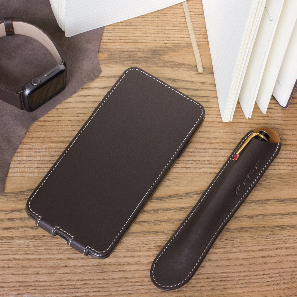 Brown leather flip case for iPhone XS Max - flat lay with Apple Watch and notebook