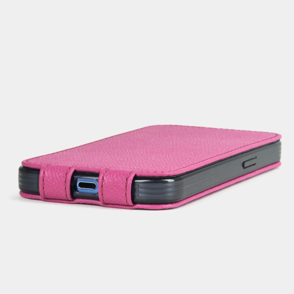 Pink calfskin leather flip case for iPhone 15 Plus – bottom view with USB-C port opening and hand-stitched edges