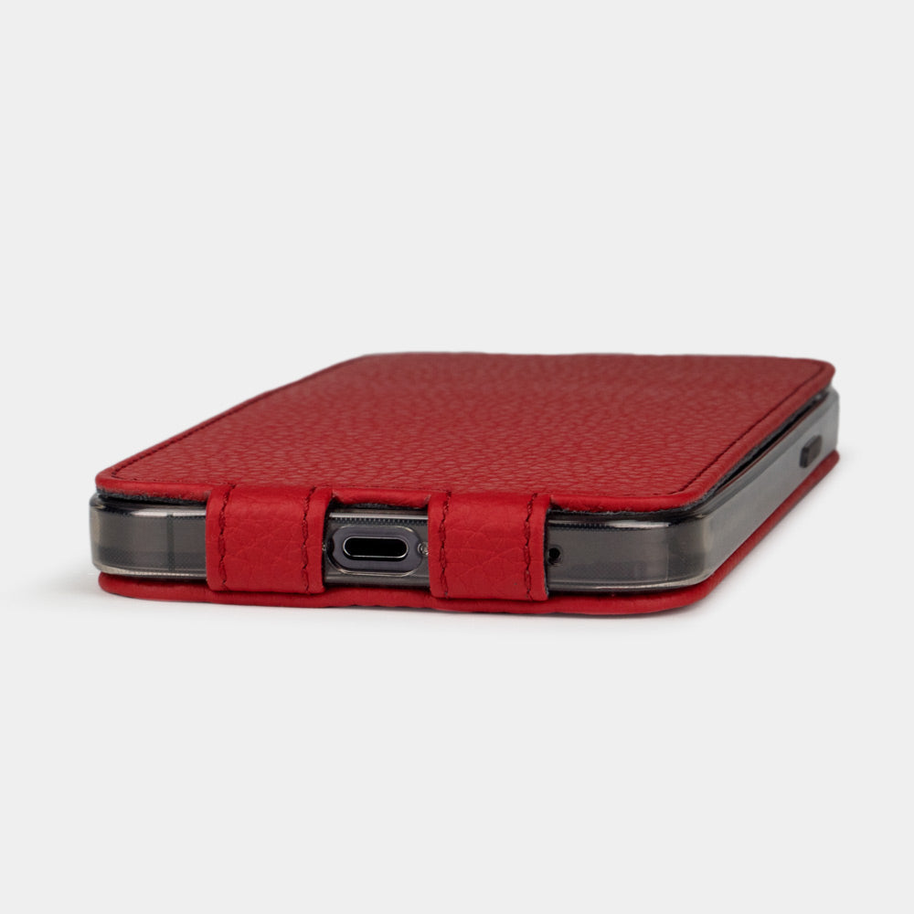 Red calfskin leather flip case for iPhone 15 – bottom view with USB-C port opening and hand-stitched edges