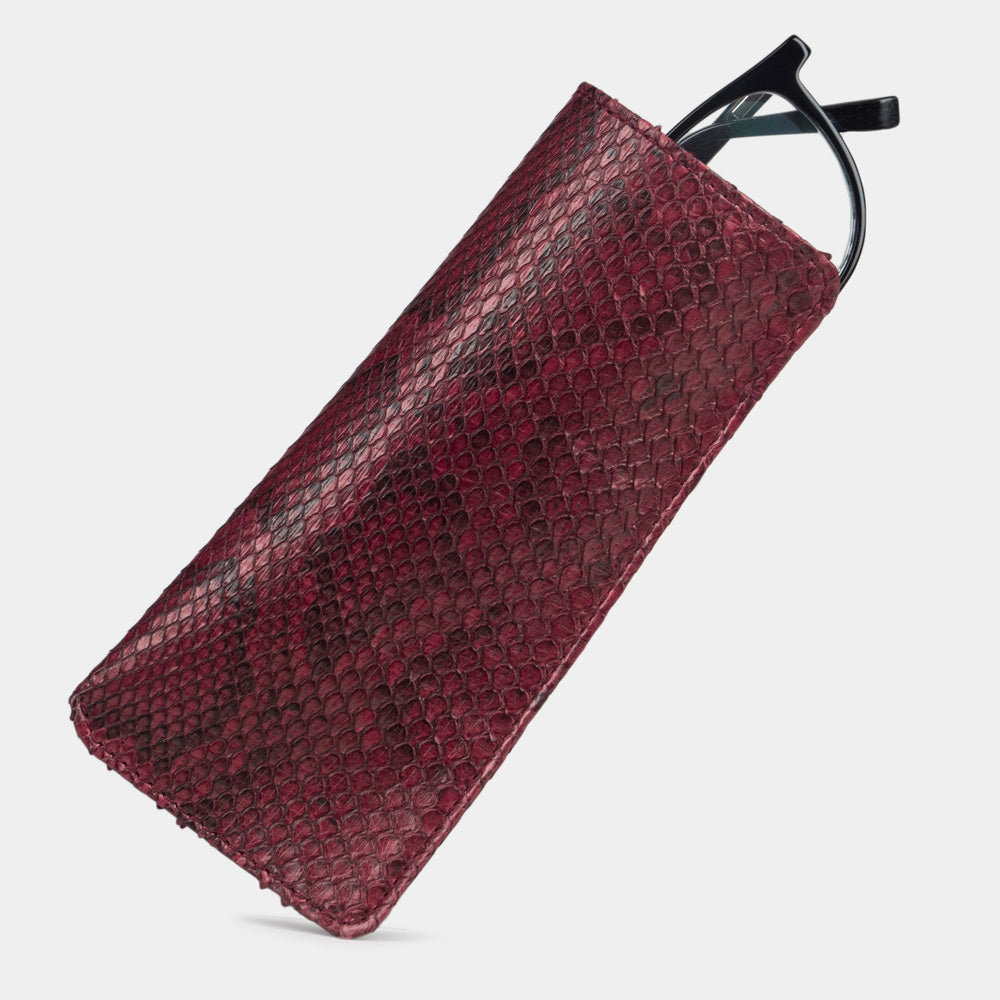 Pocket glasses pouch in bordeaux python with glasses slipping out of the top