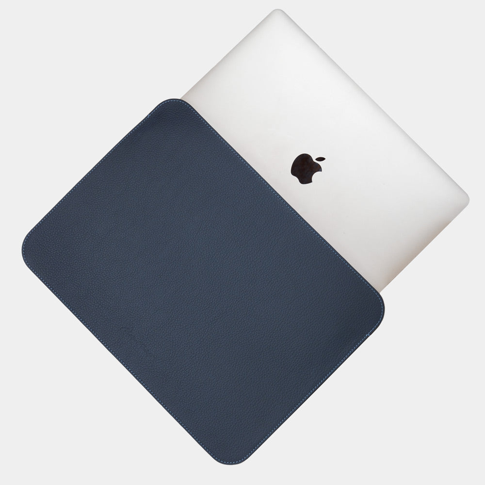 Blue 14 inch leather laptop sleeve with MacBook partially inserted, slim minimalist MacBook case